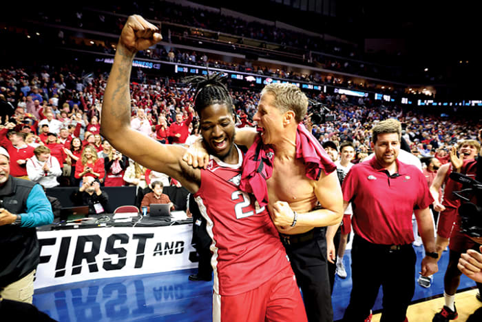 Arkansas Razorbacks head coach Eric Musselman celebrates with forward Makhel Mitchell after defeating the Kansas Jayhawks at Wells Fargo Arena.